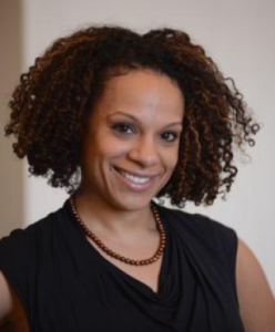 Photo of Dr. Diana Hernandez wearing a black sleeveless top and a necklace.
